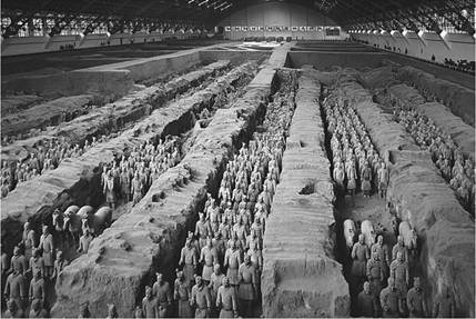 These life-sized (6 to 6 1/2 feet high) terra cotta warriors, in battle formation adjacent to the tomb of the First Qin Emperor in Shaanxi province, were intended to protect the emperor’s tomb in the afterlife. In three pits near the tomb, archaeologists have discovered 8,000 warriors, 130 chariots with 520 horses, plus 150 cavalry horses, all made of terra cotta, most of which have not yet been excavated. These life-sized (6 to 6 1/2 feet high) terra cotta warriors, in battle formation adjacent to the tomb of the First Qin Emperor in Shaanxi province, were intended to protect the emperor’s tomb in the afterlife. In three pits near the tomb, archaeologists have discovered 8,000 warriors, 130 chariots with 520 horses, plus 150 cavalry horses, all made of terra cotta, most of which have not yet been excavated.