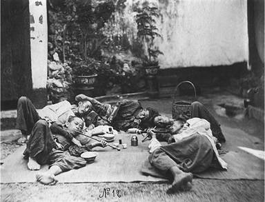 Opium smoking induced feelings of elation and also lethargy, as these men show by indulging in their habit in prone positions on their portable mat in a garden Opium smoking induced feelings of elation and also lethargy, as these men show by indulging in their habit in prone positions on their portable mat in a garden