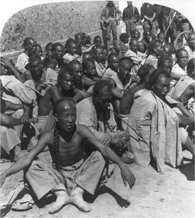 A stereographic photograph labeled “Some of China’s trouble-makers" shows Boxer prisoners captured by the 6th U.S. Cavalry in Tianjin A stereographic photograph labeled “Some of China’s trouble-makers" shows Boxer prisoners captured by the 6th U.S. Cavalry in Tianjin