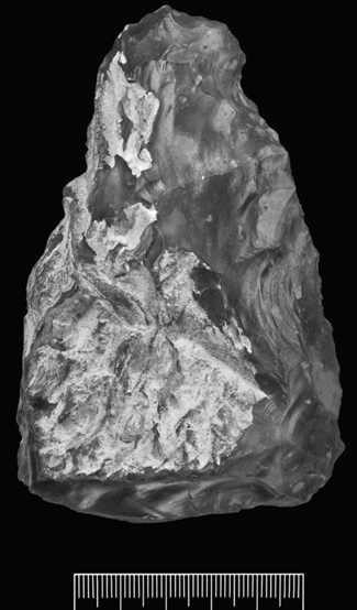 A photograph of a roughly made handaxe with cortex over the face