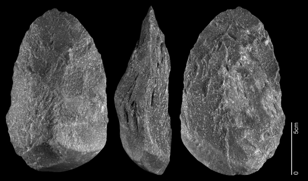 Phtograph of a large purple-yellow quartzite handaxe Oval in shape.
