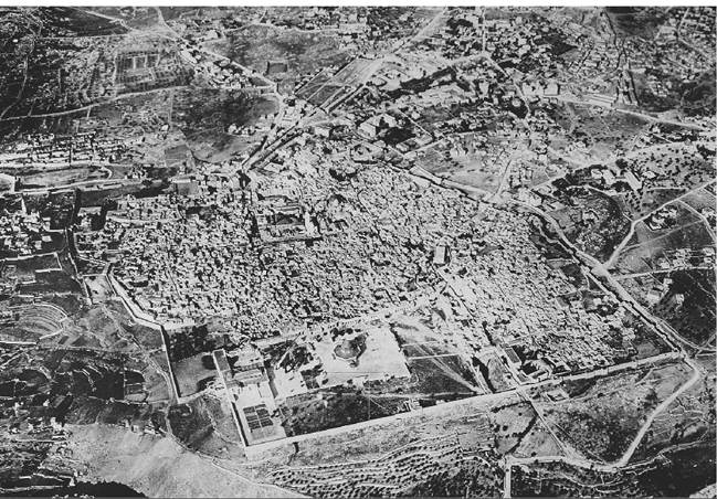 Aerial photograph of the Old City of modern Jerusalem (from the east), showing the layout of the medieval city. At the center of the western (top) section of the walls is the citadel (Tower of David) and nearby Jaffa Gate; to its right and below, the cupola of the Church of the Holy Sepulchre. The entire southeast section (bottom left) is taken up by the temple area (Haram al-Shanf) centered on the Dome of the Rock. (Courtesy Benjamin Z. Kedar)