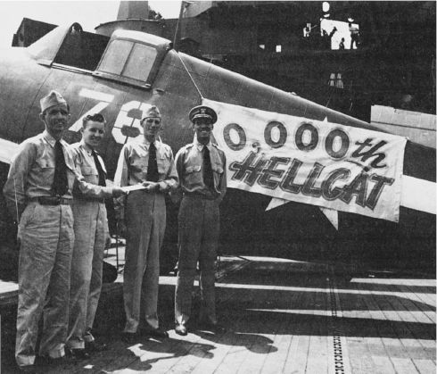The 10,000th Hellcat, an F6F-5, was delivered to VBF-87 aboard the USS Ticonderoga in May of 1945. From left to right are: Lieutenant Commander Charles Ingalls; Grumman tech rep Ralph Clark; Commander Porter Maxwell, the CO of VBF-87; and Commander Everett L. Phadres, CAG-87. Photo: Grumman